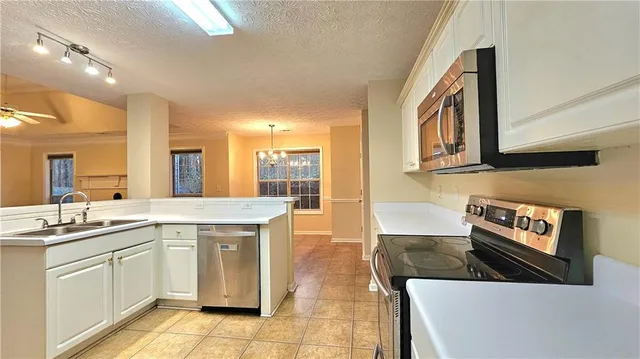 a kitchen with stainless steel appliances granite countertop a sink and cabinets