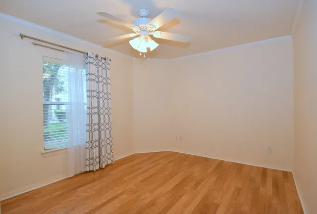 a view of a hallway with wooden floor and staircase