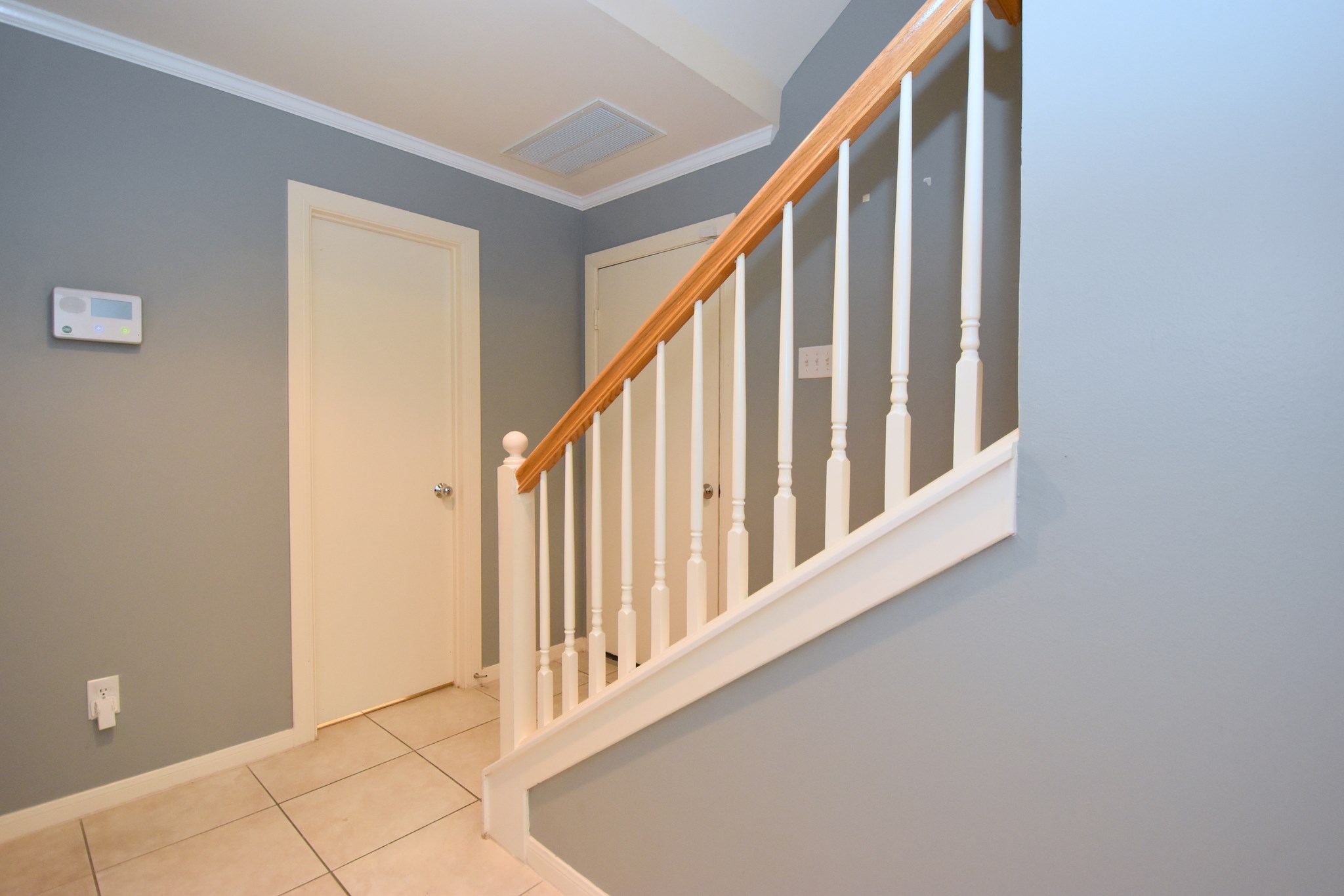 1267 West 17th Street Houston, TX 77008 - Photo 4 of 22 Elegant ground-level staircase with classic wood banister and modern finishes.