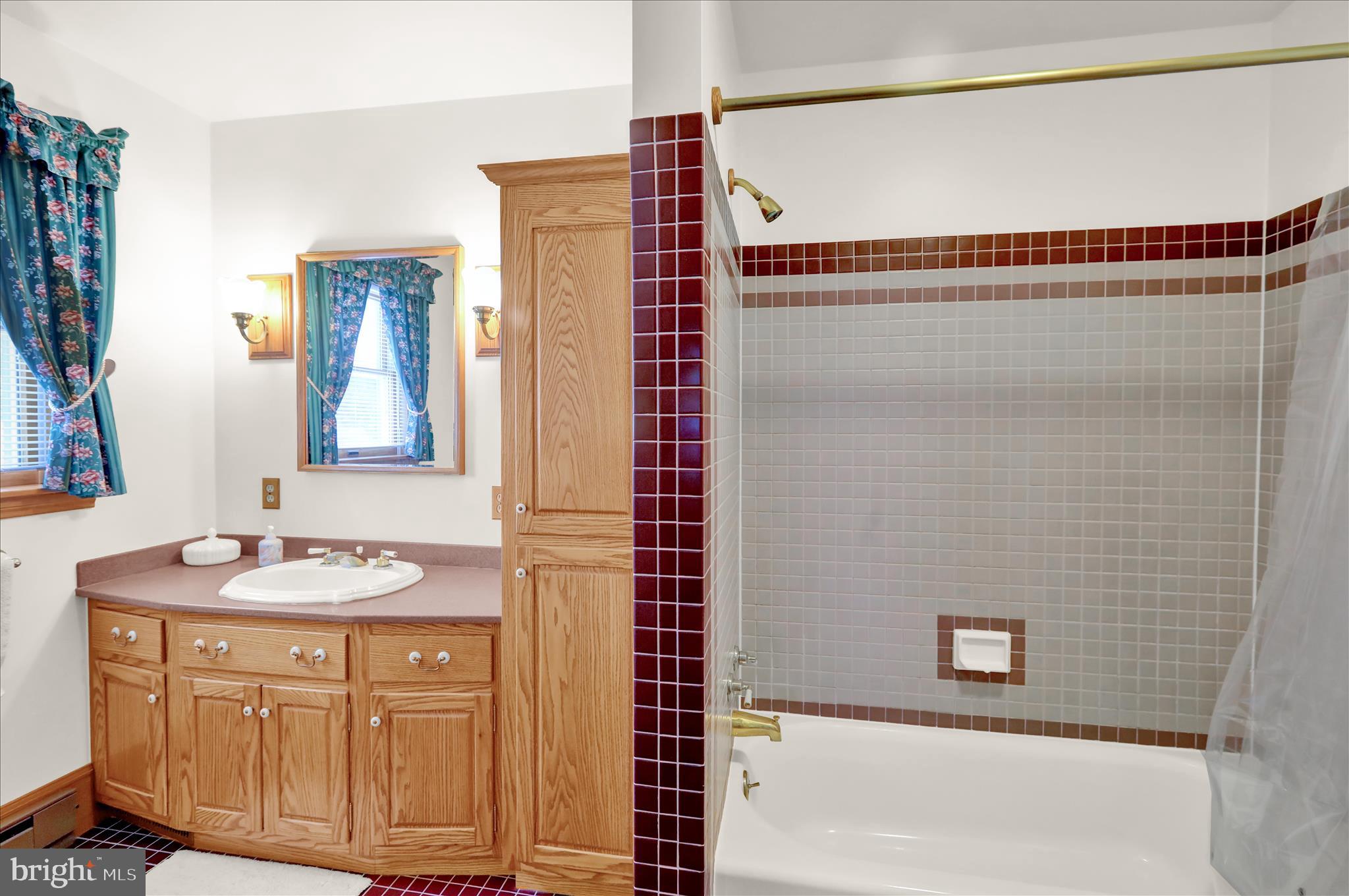 2904 Gerard Avenue Reading, PA 19608 - Photo 22 of 39 a bathroom with a sink and a mirror