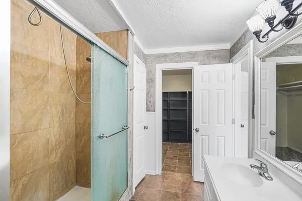 a bathroom with a shower and a sink