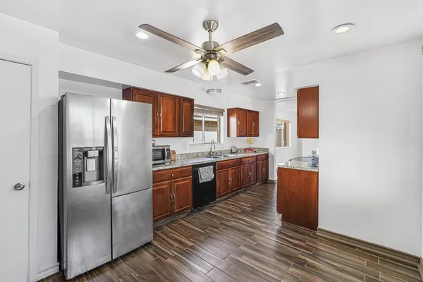 a kitchen with stainless steel appliances a refrigerator sink and stove