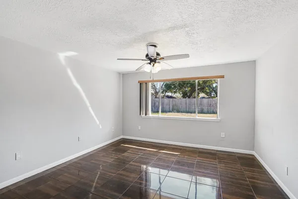 a view of a livingroom with a ceiling fan and window