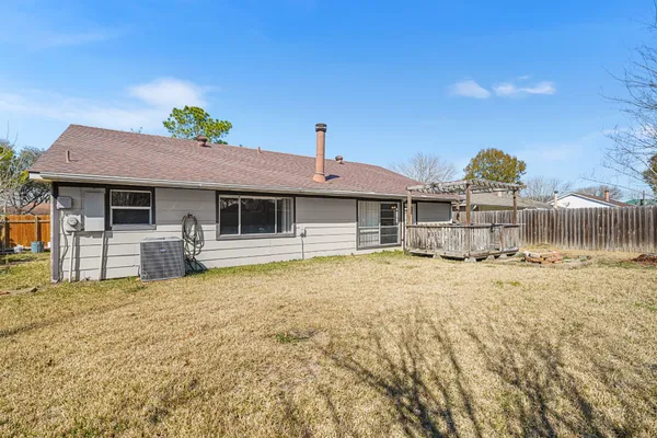 a view of a house with wooden fence