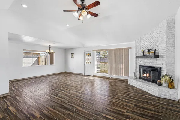 a view of an empty room with window and fire place