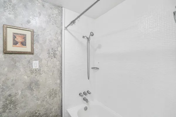 a bathroom with a bathtub and shower