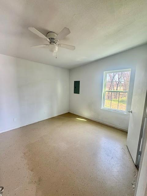 898 East Reno Road Azle, TX 76020 - Photo 2 of 6 an empty room with windows and fan