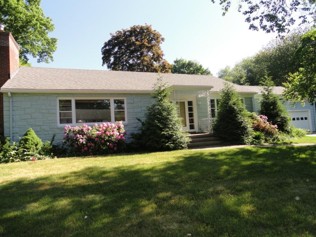 a front view of house with yard and green space