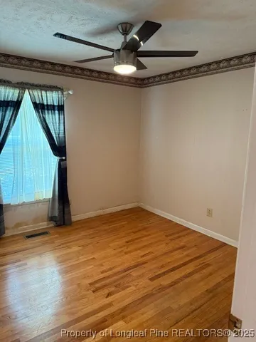 a view of an empty room with a kitchen