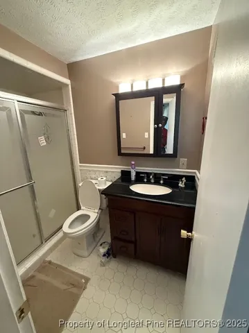 a bathroom with a shower and a toilet