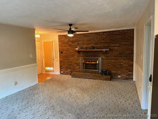 an empty room with wooden floor a ceiling fan and window