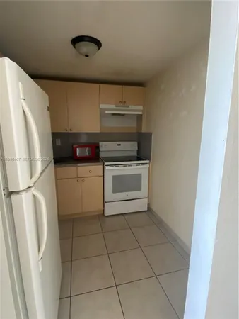 a kitchen with a stove a refrigerator and a sink