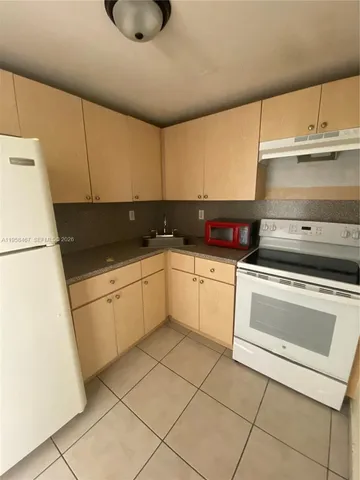 a kitchen with a white cabinets and white appliances