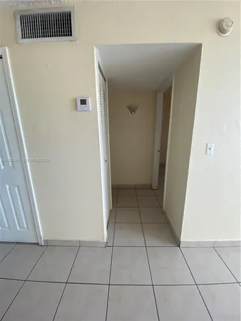 a view of a livingroom with an empty space and a window