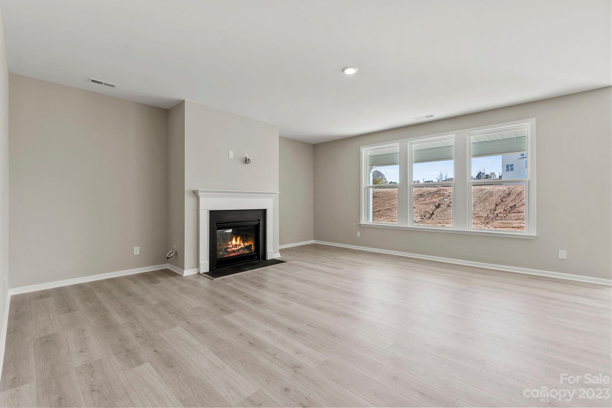 4130 Charlton Road Fort Mill, SC 29715 - Photo 8 of 24 a view of an empty room with a window and fireplace