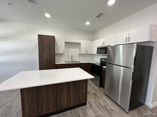 a kitchen with a refrigerator and a sink