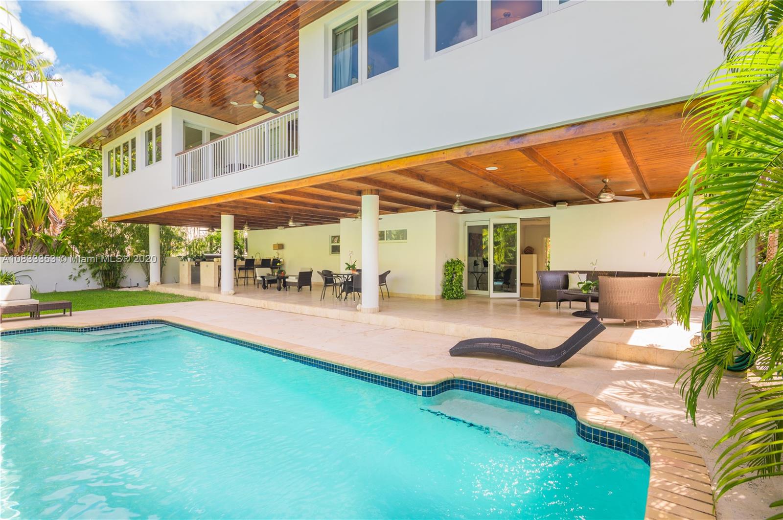 472 Warren Lane Key Biscayne, FL 33149 - Photo 1 of 39 a view of a patio with swimming pool table and chairs
