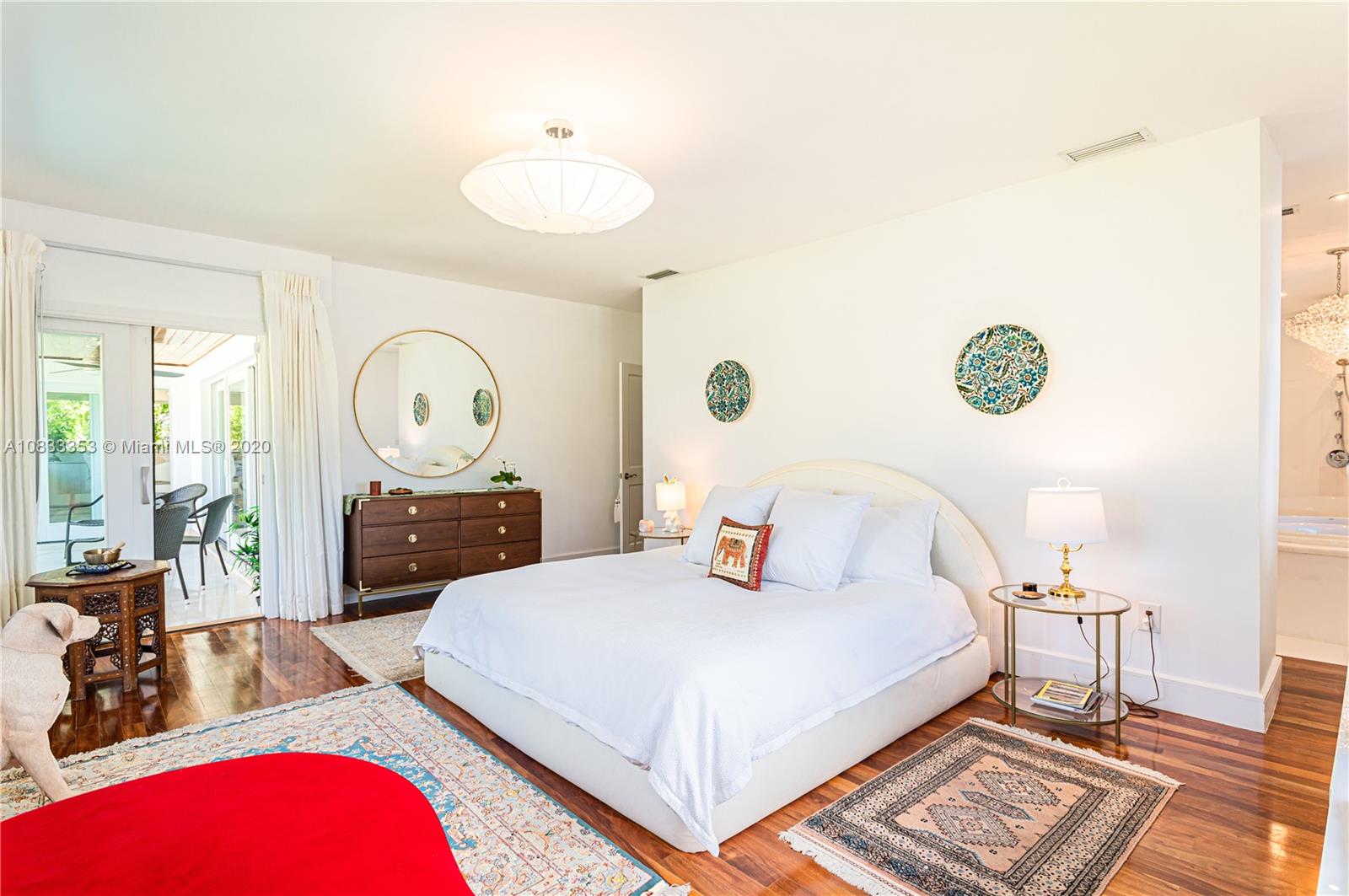 472 Warren Lane Key Biscayne, FL 33149 - Photo 21 of 39 a bedroom with a bed a mirror and a table