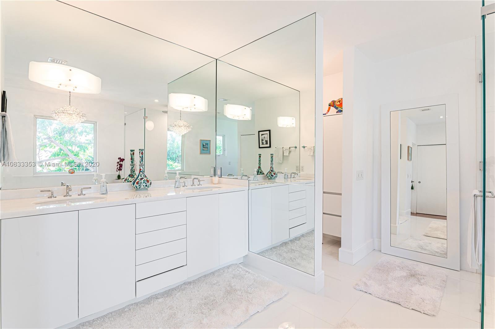 472 Warren Lane Key Biscayne, FL 33149 - Photo 24 of 39 a bathroom with a double vanity sink and a mirror