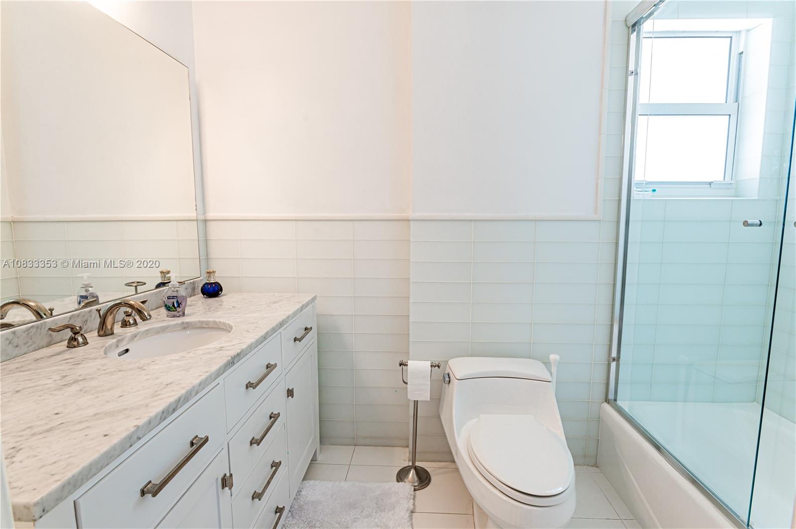 472 Warren Lane Key Biscayne, FL 33149 - Photo 27 of 39 a bathroom with a granite countertop toilet sink and mirror