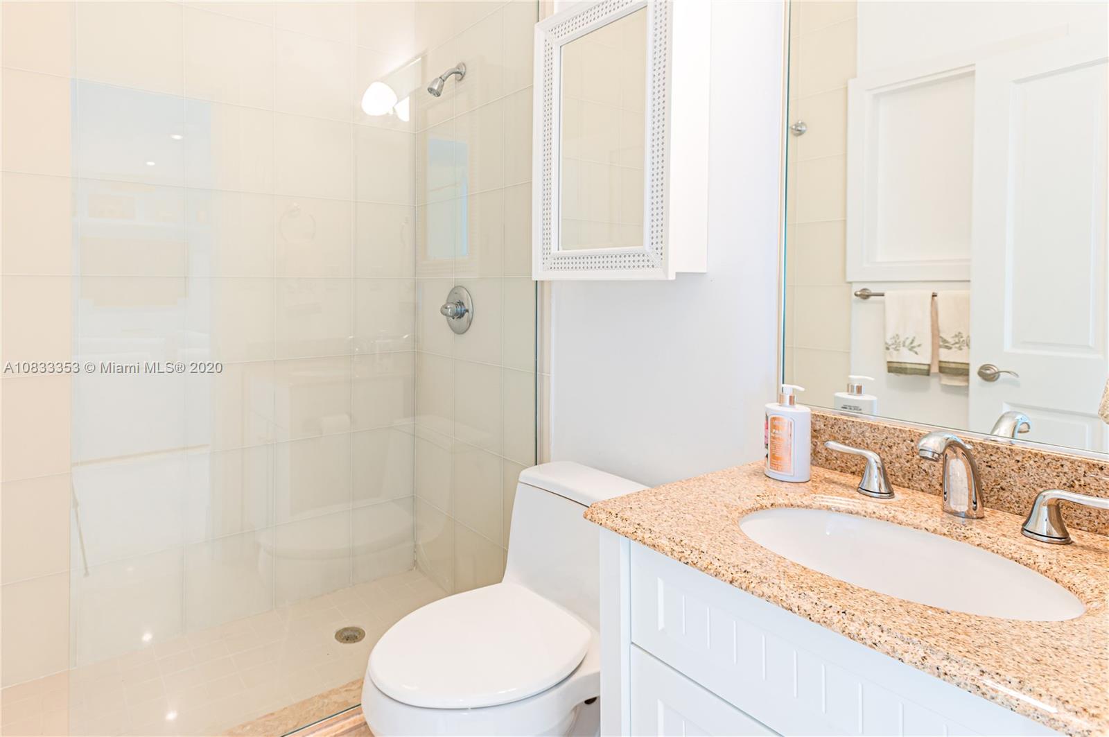 472 Warren Lane Key Biscayne, FL 33149 - Photo 34 of 39 a bathroom with a granite countertop sink toilet and shower