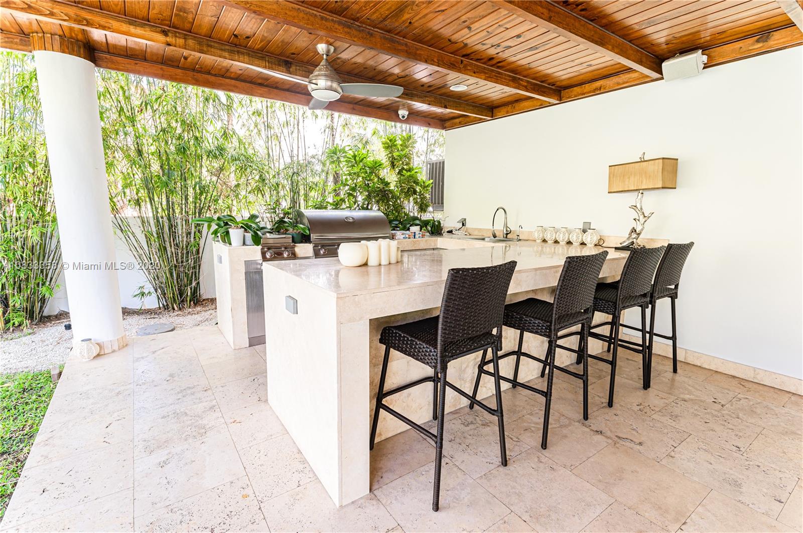 472 Warren Lane Key Biscayne, FL 33149 - Photo 36 of 39 a view of a patio with a table and chairs under an umbrella