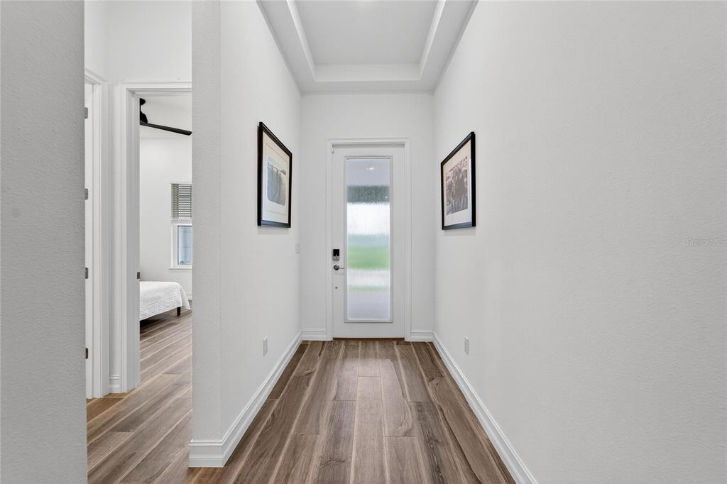 1071 Seagrape Drive Ruskin, FL 33570 - Photo 3 of 100 a view of a hallway with wooden floor and a bathroom