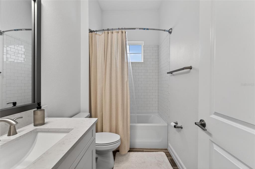 1071 Seagrape Drive Ruskin, FL 33570 - Photo 34 of 100 a bathroom with a sink toilet and shower