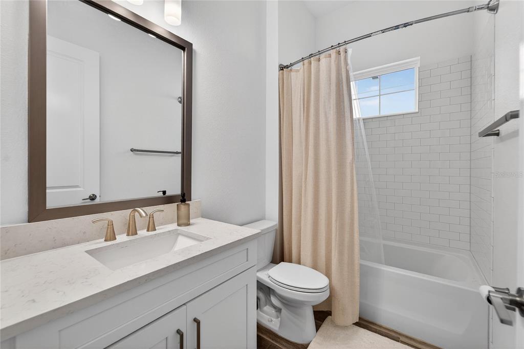 1071 Seagrape Drive Ruskin, FL 33570 - Photo 35 of 100 a bathroom with a sink a toilet and shower