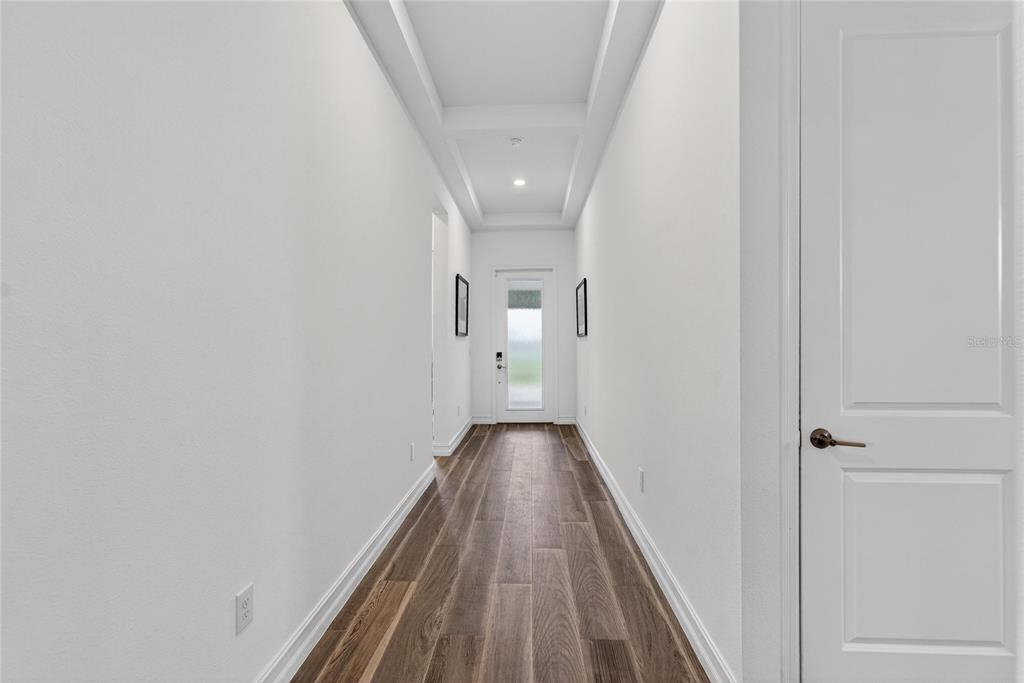 1071 Seagrape Drive Ruskin, FL 33570 - Photo 42 of 100 a view of a hallway with wooden floor and a hallway