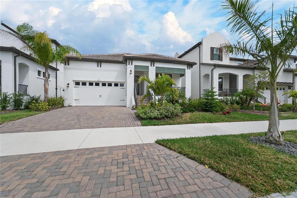 1071 Seagrape Drive Ruskin, FL 33570 - Photo 50 of 100 a front view of a house with a yard and a garage