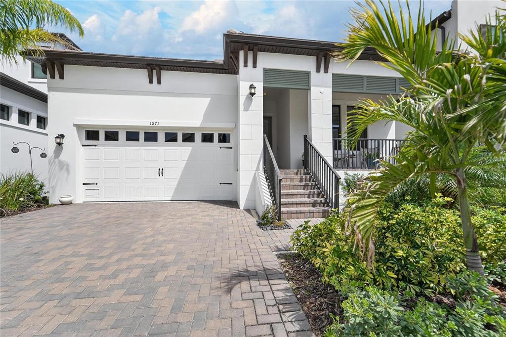 1071 Seagrape Drive Ruskin, FL 33570 - Photo 54 of 100 a front view of a house with a yard and garage