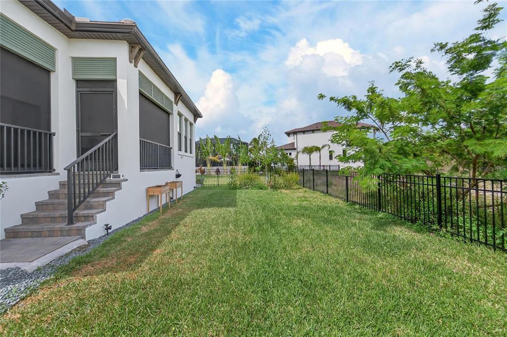1071 Seagrape Drive Ruskin, FL 33570 - Photo 59 of 100 a view of a white house next to a yard with big trees
