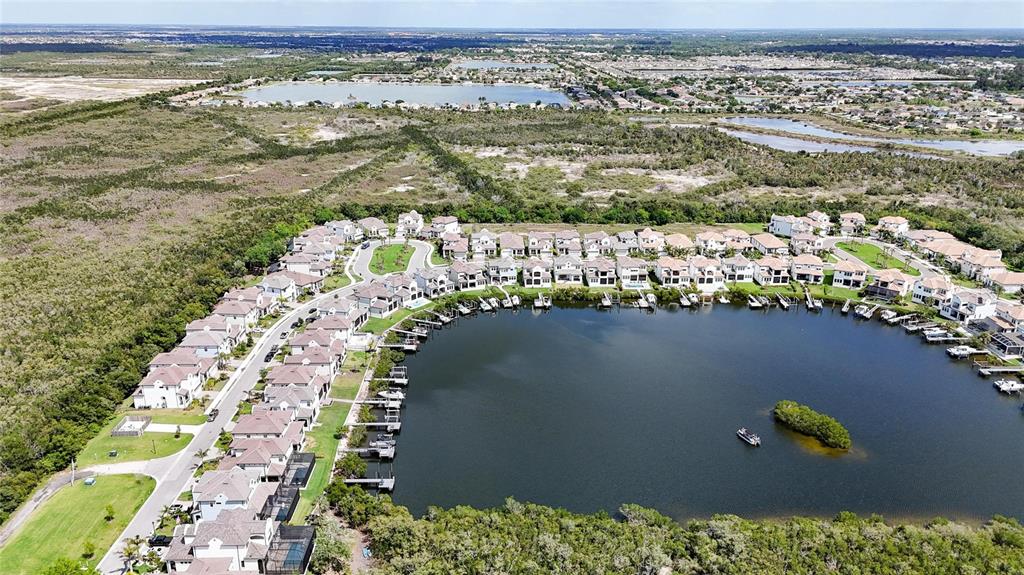 1071 Seagrape Drive Ruskin, FL 33570 - Photo 92 of 100 an aerial view of ocean and residential houses with outdoor space