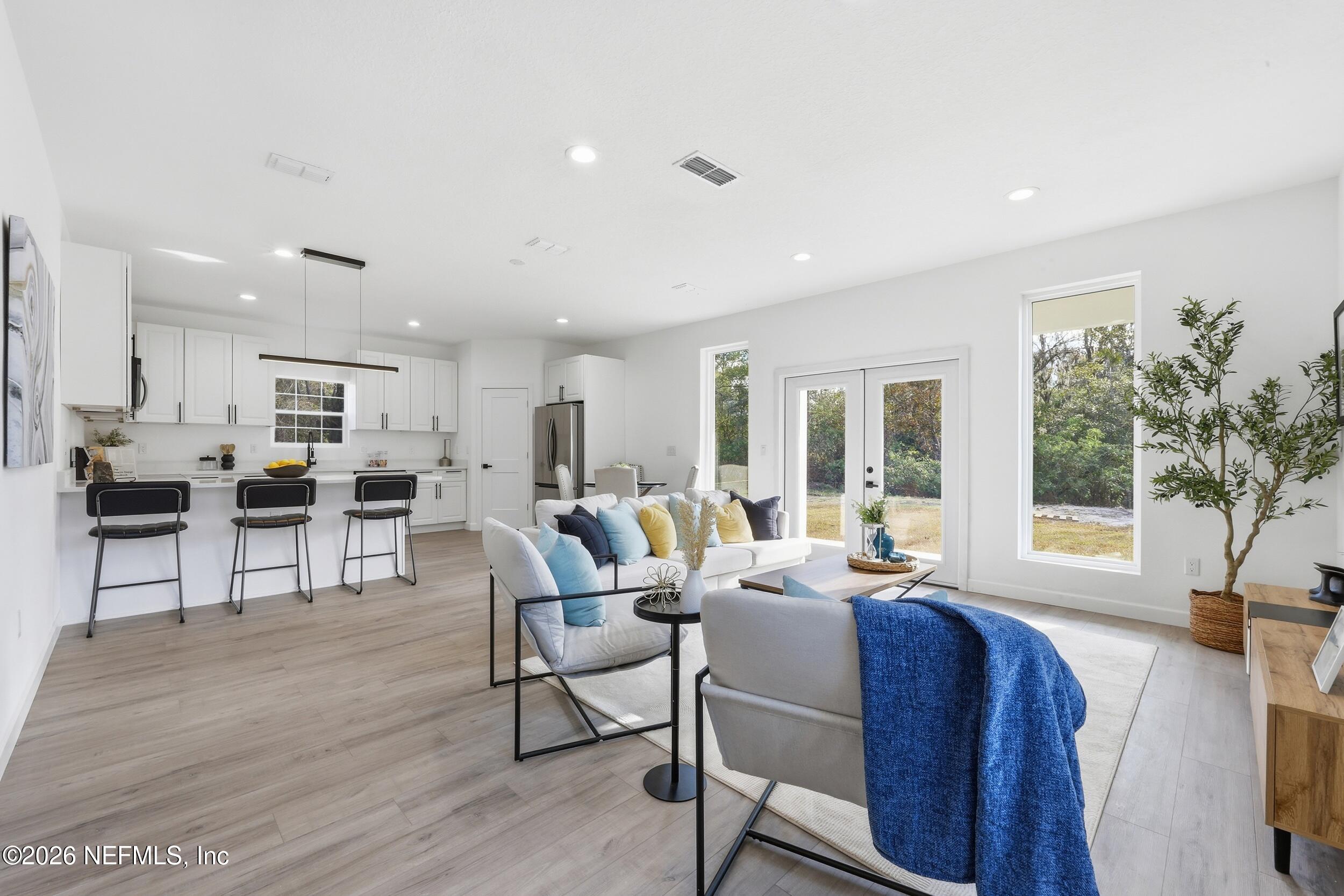 4199 Pine Road Orange Park, FL 32065 - Photo 13 of 44 a living room with furniture and large windows