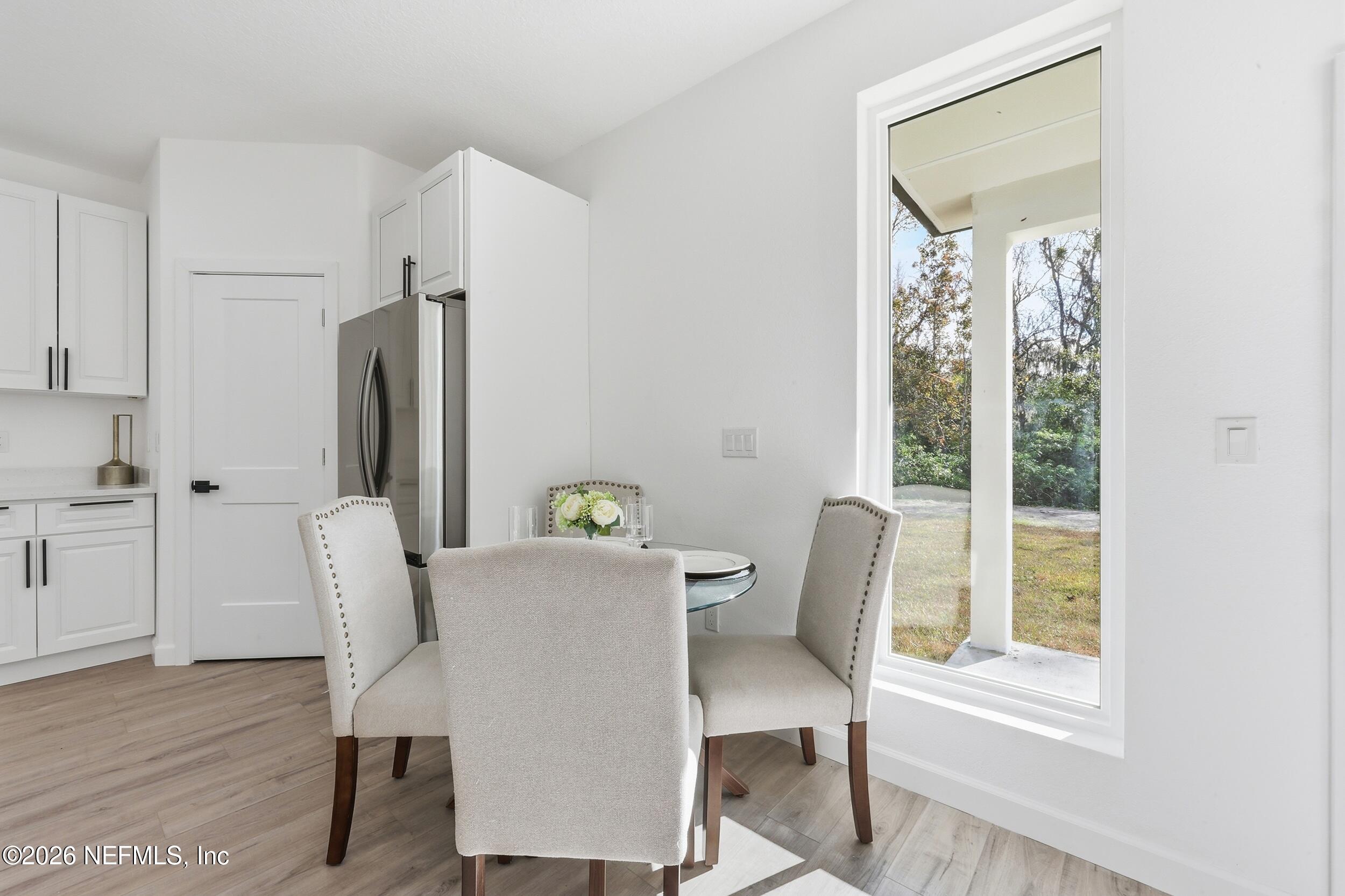 4199 Pine Road Orange Park, FL 32065 - Photo 15 of 44 a view of a dining room with furniture window and wooden floor
