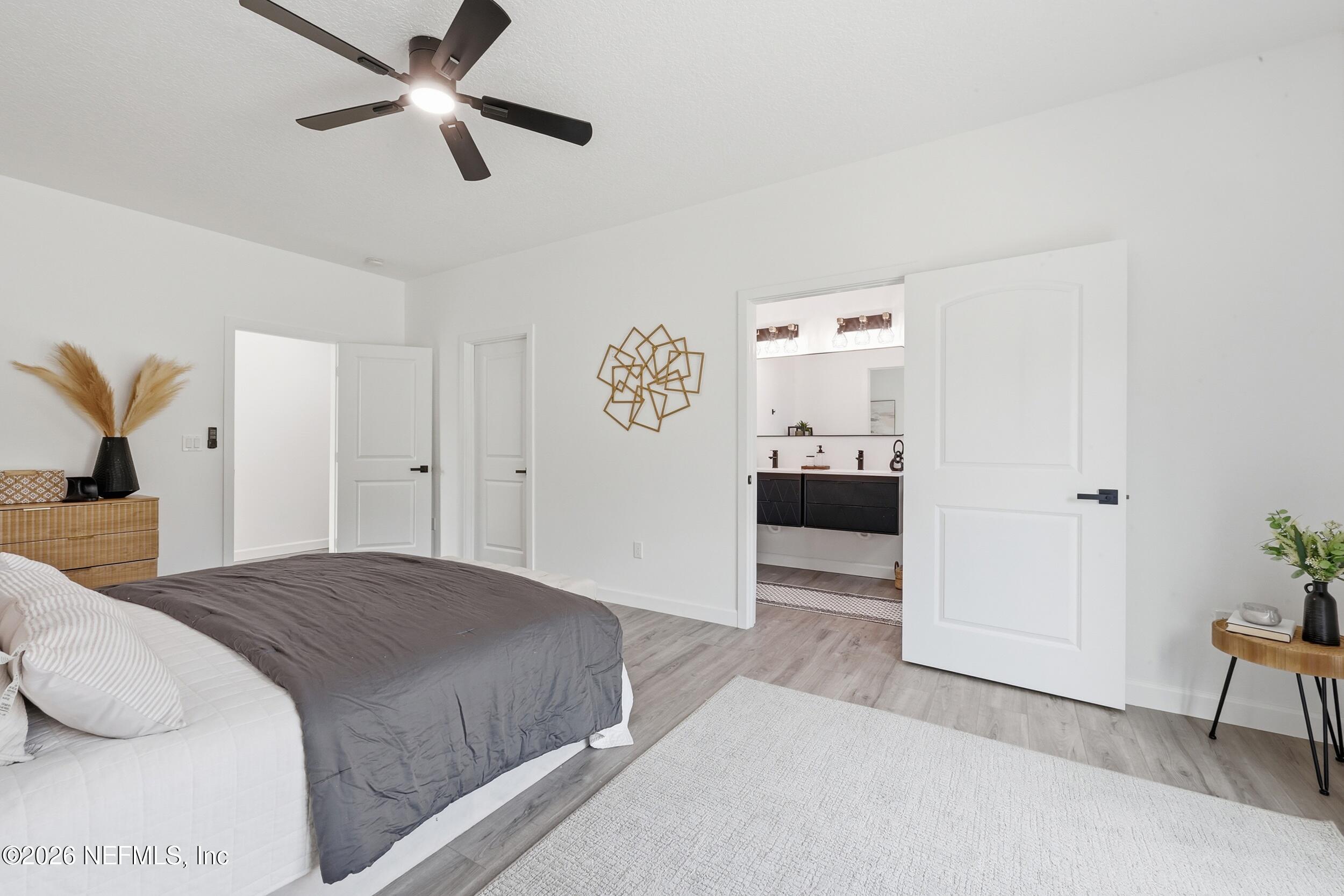 4199 Pine Road Orange Park, FL 32065 - Photo 21 of 44 a bedroom with a bed and a chandelier