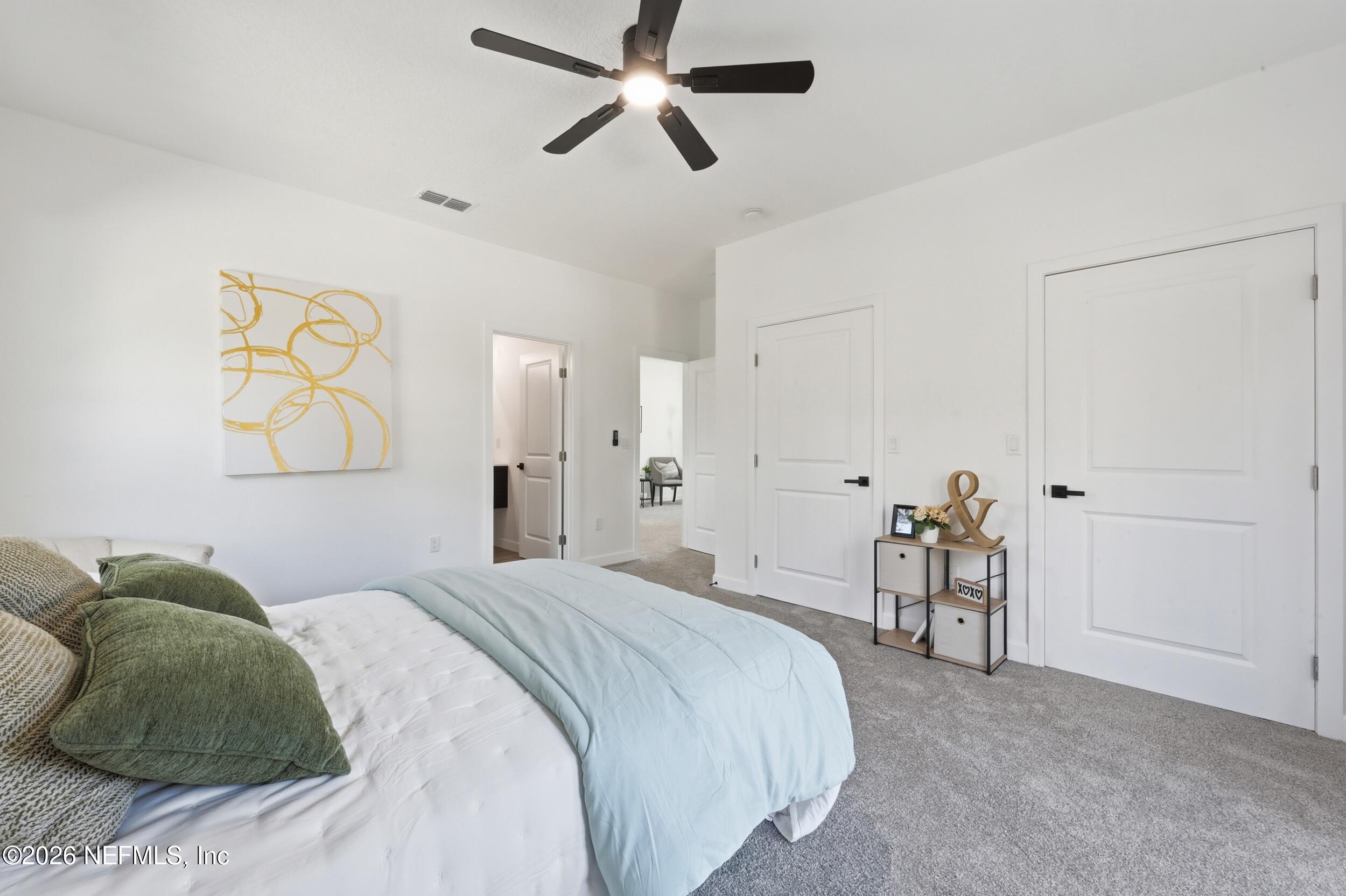 4199 Pine Road Orange Park, FL 32065 - Photo 31 of 44 a bedroom with a bed and a chandelier