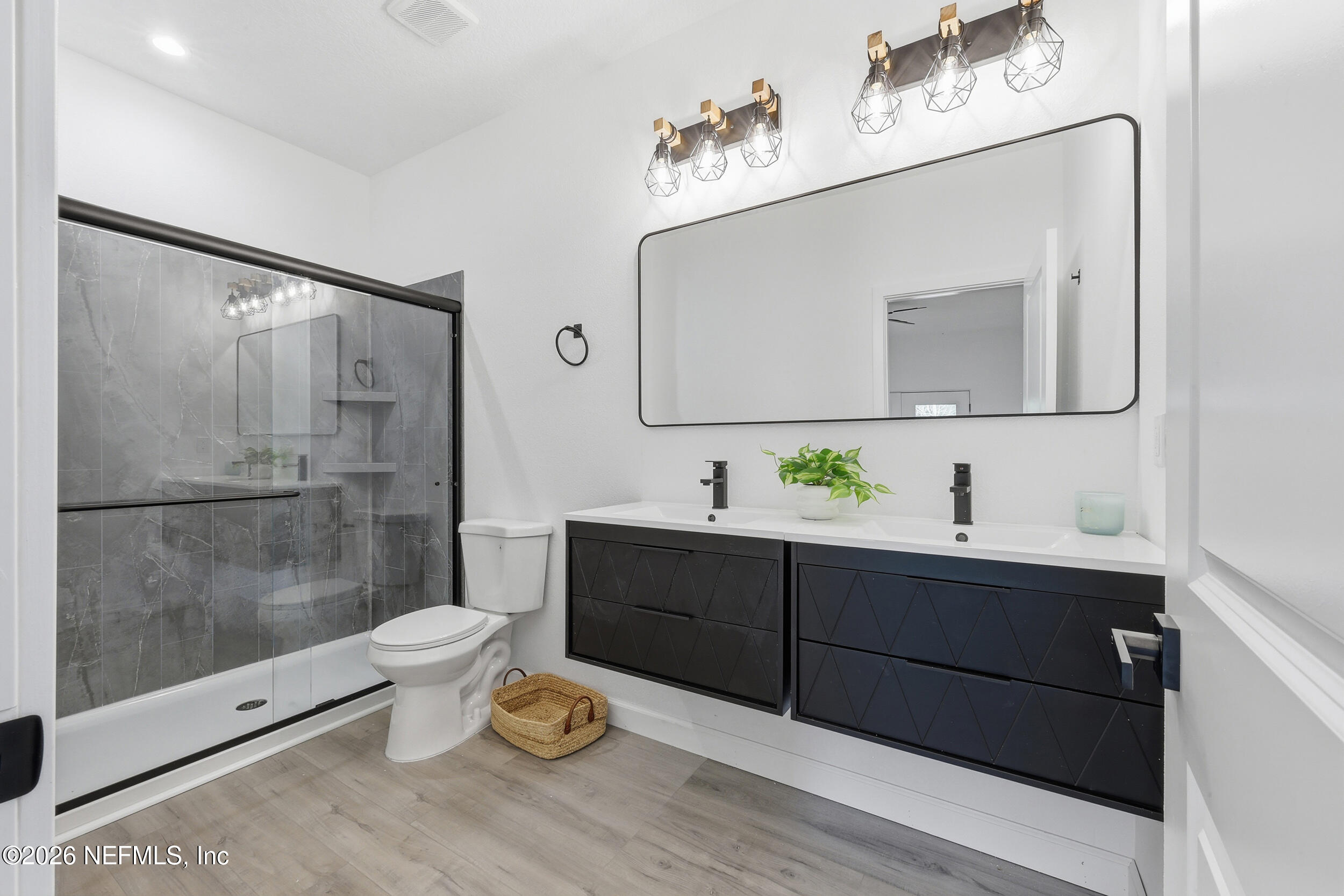 4199 Pine Road Orange Park, FL 32065 - Photo 32 of 44 a spacious bathroom with a double vanity sink toilet and shower