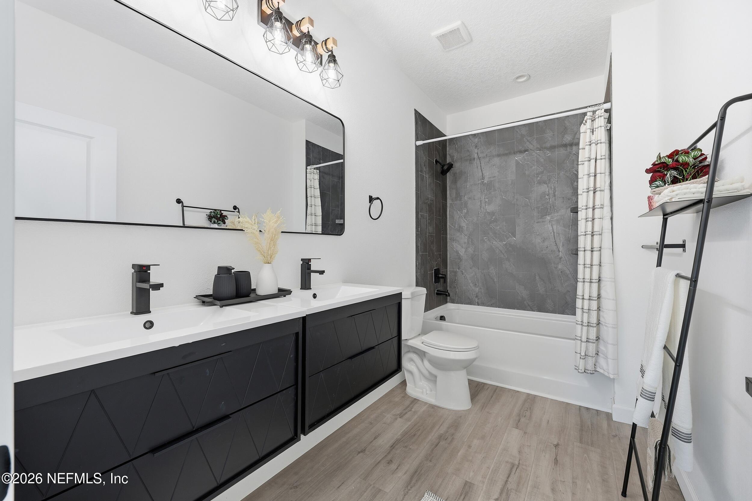 4199 Pine Road Orange Park, FL 32065 - Photo 36 of 44 a bathroom with a double vanity sink toilet mirror and shower