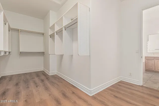 a bedroom with a bed and a potted plant