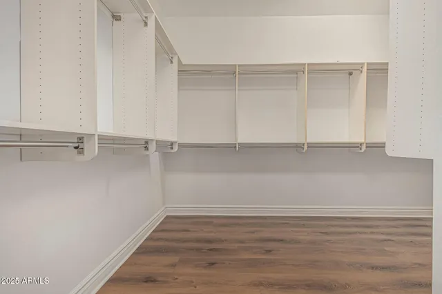 a view of a grey house with large windows