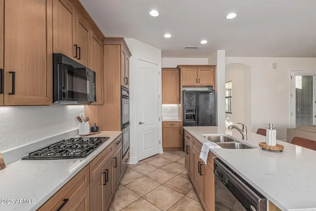 a kitchen with a sink stove top oven and refrigerator