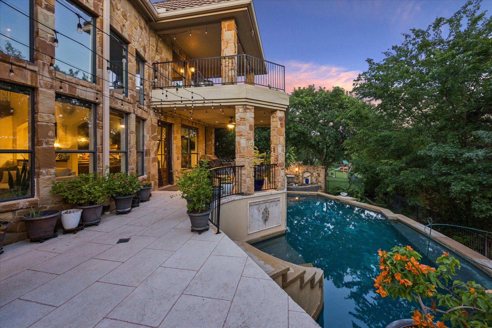 11805 Ranchview Court Austin, TX 78732 - Photo 29 of 36 Exterior stone facade featuring multiple large windows