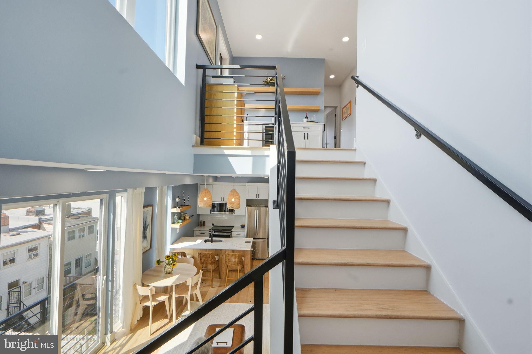 623 Kennedy Street Northwest, Unit 10 Washington, DC 20011 - Photo 18 of 34 a view of staircase with lots of frames on wall and windows