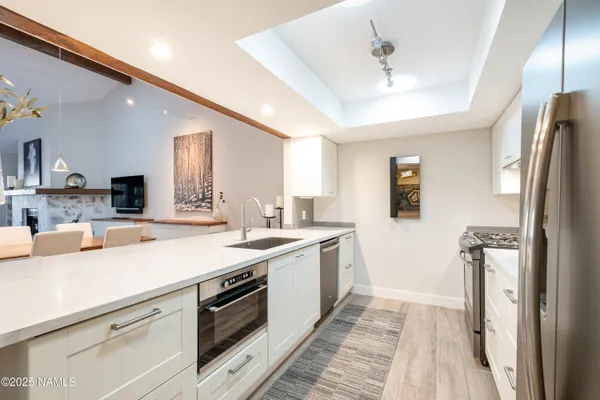 a kitchen with a sink appliances and cabinets