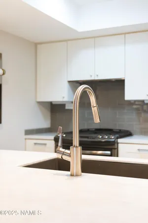 a room with stainless steel appliances kitchen island granite countertop furniture and a view of living room