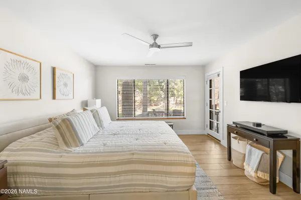 a bedroom with a large bed and a chandelier