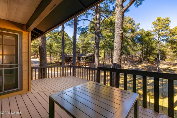 a view of a house with backyard and deck