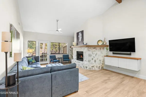 a living room with fireplace furniture and a flat screen tv